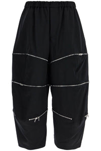 COMME DES GARCONS BLACK cropped pants with zip openings.